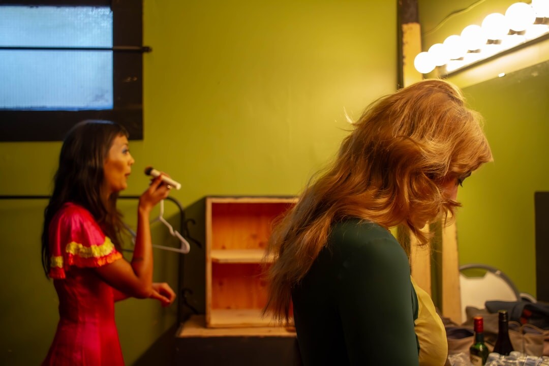 Backstage candid of stylists preparing models before a fashion show