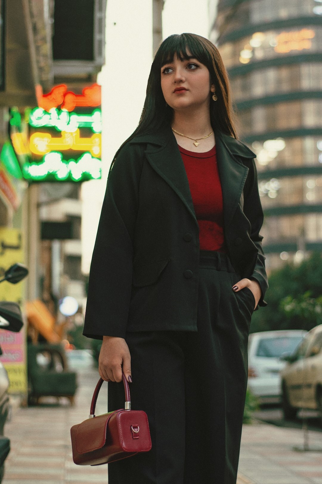 Fashion editorial photo of a woman in a tailored coat on a city street