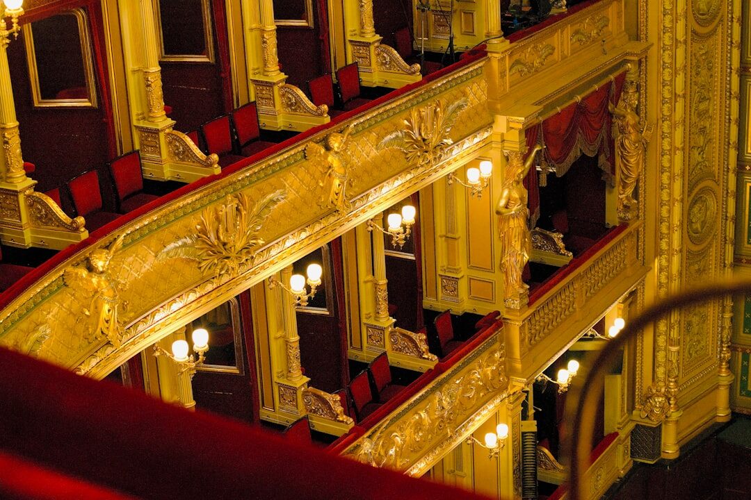 Grand opera house interior with ornate balconies and golden light